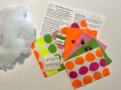 Colorful fleece pieces of fabric neon dots in pink green orange and yellow with patterns and an instruction booklet 
with text on a white background
